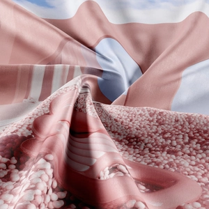 Macro shot of silky bohemian tapestry fabric with pink and white abstract patterns
