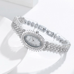 Macro shot of silver oval ladies watch fully encrusted with sparkling crystals and diamonds