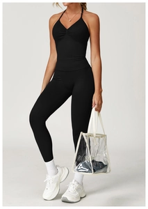Detail of black seamless yoga set featuring ruched racerback tank and high waist leggings