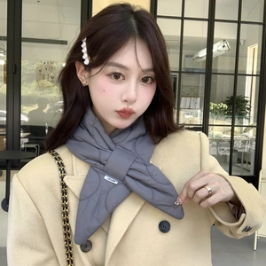 Detail of gray quilted scarf with cross-pull closure and small logo tag for women