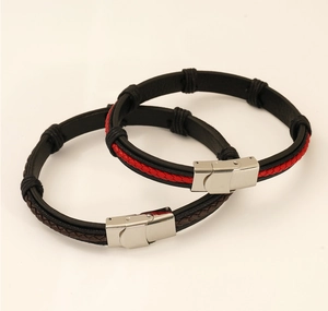 Detail of dual-tone braided leather bracelets with polished stainless steel magnetic clasps