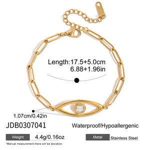 Macro detail of 18K gold stainless steel chain bracelet with evil eye and crystal charm