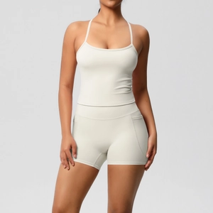 Detail of cream yoga set showing back strap design and side pockets on shorts