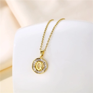 Close-up of 18K gold stainless steel necklace with letter Q pendant and baguette zircons