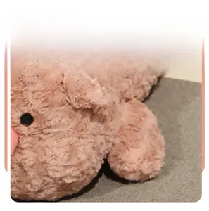 Macro shot of fluffy pink plush toy with spiral faux fur texture and dense filling