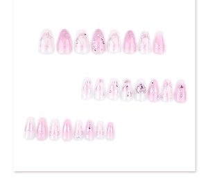 Detail of almond press-on nails with pink gradient, 3D hearts, bows, and sparkling rhinestones