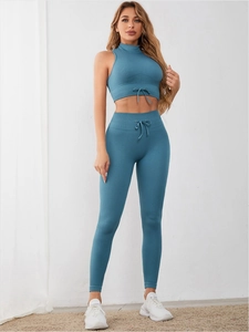 Detail of ribbed peacock blue yoga set featuring adjustable drawstring waist and neckline