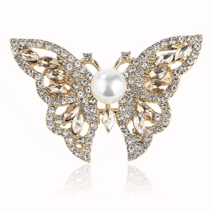 Elegant butterfly brooch with white pearls and sparkling crystals on golden alloy base