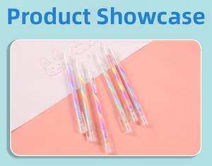 Close-up of 6 rainbow spiral gel pens with transparent barrels on a pastel pink surface