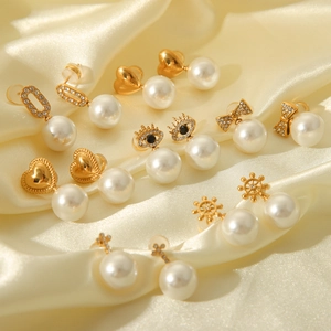French vintage style earrings set with pearls and gold bow heart studs on silk