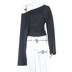 Detail of black slim fit off-shoulder long sleeve top with waist ruching and draping