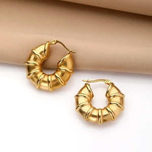 Polished gold croissant hoop earrings with a chunky ribbed texture and leverback closure