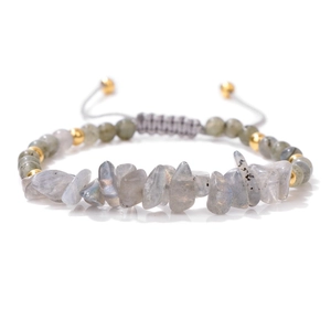 Detailed macro view of woven bracelet with natural crushed labradorite and gold beads