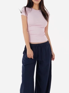 Slim fit pale pink rib-knit t-shirt paired with navy drawstring wide-leg pants