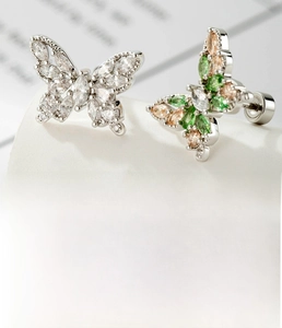 Macro shot of silver titanium steel butterfly studs with micro-set colorful zircons