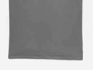 Detailed view of grey fabric with professional flat seam stitching and fine texture