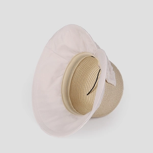 Detail of wide brim sun hat with straw woven crown and adjustable windproof cord