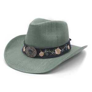 Detail of sage green woven cowboy hat featuring floral embroidery and a vintage metal buckle