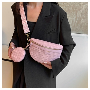 Detail view of pink woven texture crossbody bag with gold hardware and wide strap