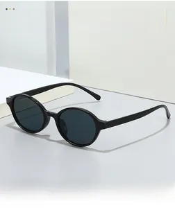 Detailed close-up of retro black oval sunglasses on minimalist geometric surface
