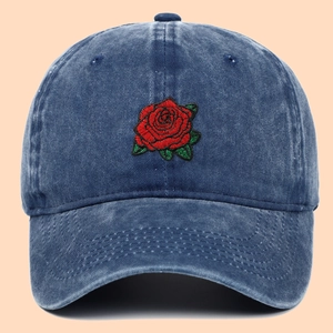 Classic washed navy denim baseball cap featuring vibrant red rose embroidery on the front