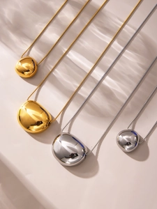 Polished pebble pendants in gold and silver finishes on delicate box chains