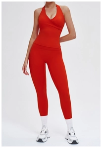 Detail of red halter yoga top and high-waisted leggings set in premium matte fabric
