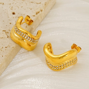 Detail of gold C-shaped twisted earrings with double-row micro-pave white zircons
