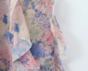 Macro view of colorful floral fabric with ruffle details and refined stitching