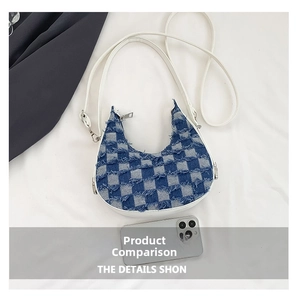 Detail of blue denim checkered crescent bag featuring frayed edges and white strap