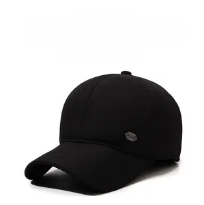 Detail shot of the side hexagonal metal logo on a thick black winter baseball cap