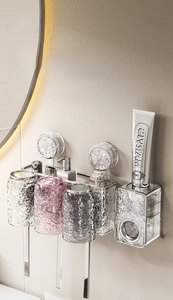 Detail of suction cup toothbrush holder with ripple texture cups and toothpaste dispenser