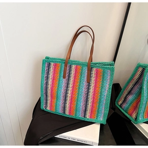 Detail of colorful striped woven tote bag with premium brown leather handles