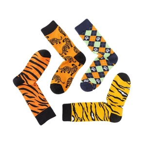 Cotton crew socks with orange tiger stripes and animal print patterns on white background