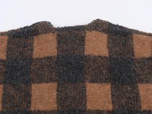 Close-up of brown and grey plaid knit sweater showing soft mohair texture and round neck