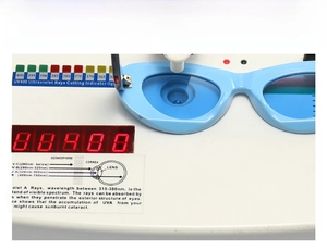 Detail of light blue cat-eye sunglasses undergoing UV400 protection testing on a device
