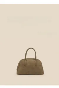 Detailed macro shot of army green suede boston bag texture and sleek metallic zipper