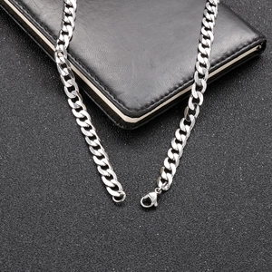 Detailed macro view of silver Cuban chain necklace with secure lobster clasp