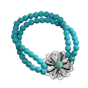 Detailed shot of bohemian turquoise beaded bracelet with silver flower charm