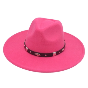 Close-up of rose pink fedora hat featuring a black leather band and silver diamond metal studs