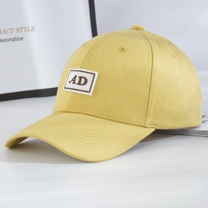 Side view of structured bright yellow baseball cap featuring AD letter embroidery