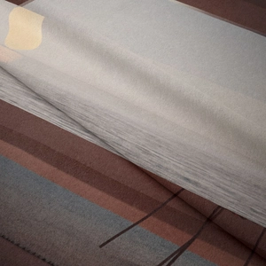 Close-up of bohemian geometric tapestry showing soft velvet texture and modern abstract patterns