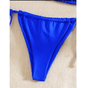 Detail of royal blue triangle bikini bottoms with adjustable side tie strings