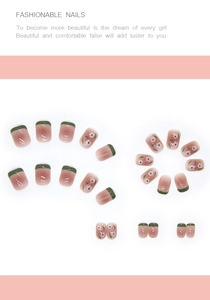 Short square press-on nails with green French tips and white flower patterns on pink base