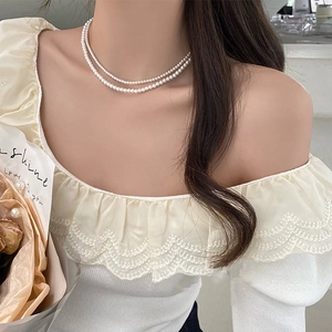 Elegant double-layer pearl necklace shown on model with French vintage aesthetic detail