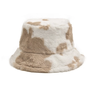 Close-up of the fluffy plush cow print bucket hat featuring soft faux fur texture