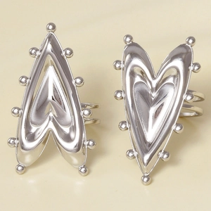 Detail of silver heart rings with bead rivet edges and polished mirror finish texture