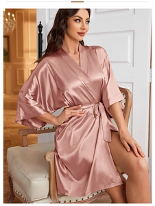 Elegant mauve satin robe featuring V-neckline and tie waist on a seated model