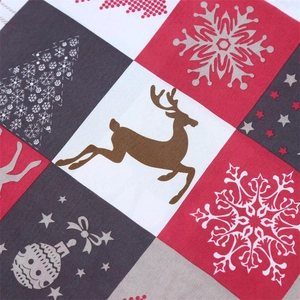 Detailed view of Christmas table runner fabric with reindeer and snowflake patterns