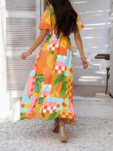 Back view of bohemian maxi dress with colorful floral print and ruffled hem details